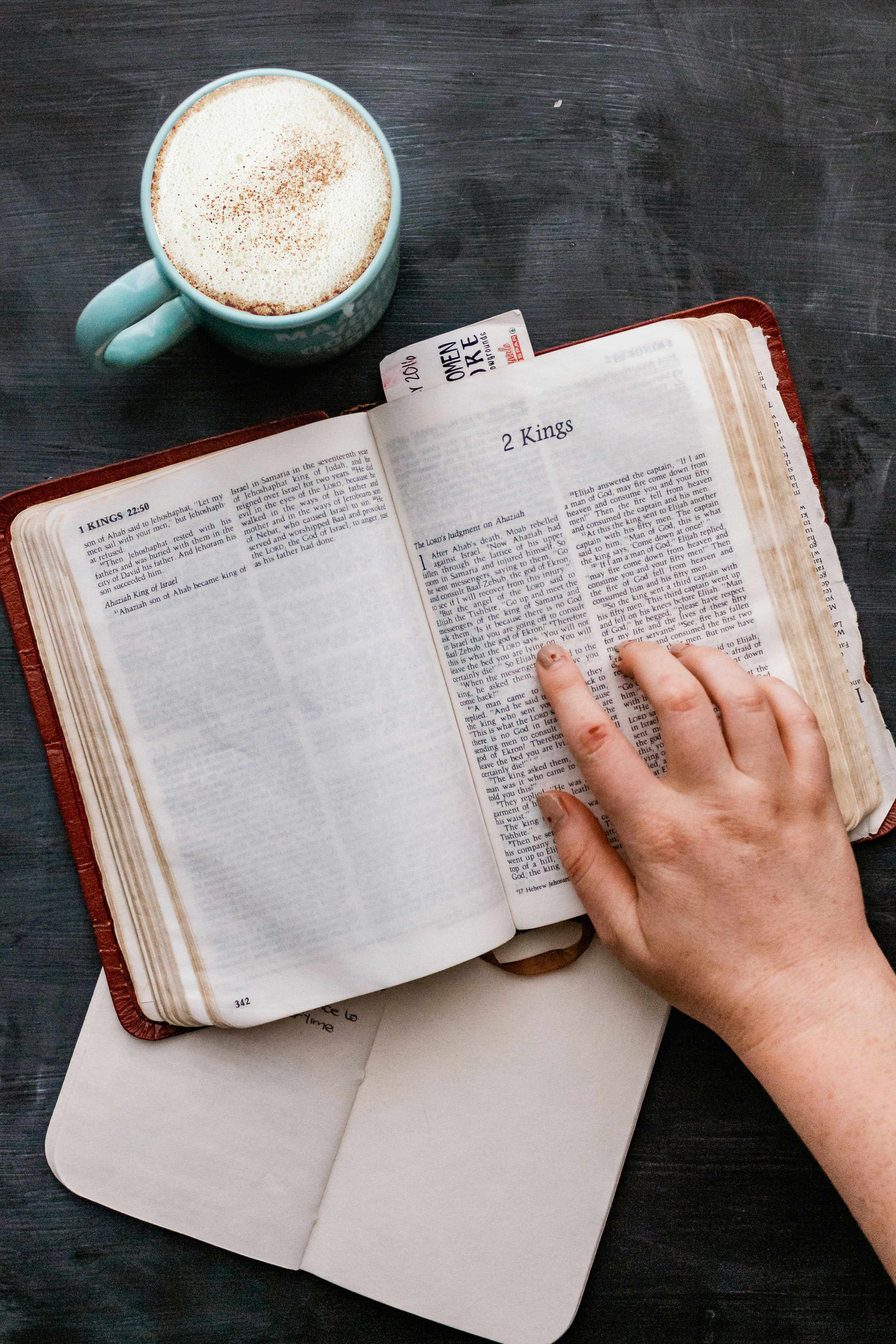 person holding white book page